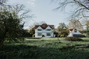Large luxury holiday house on the Dorset coast at Rushay, surrounded by lush greenery and trees. Perfect for seaside stays and coastal retreats.